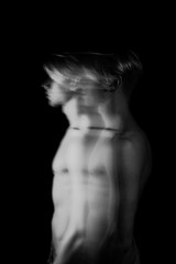 Moody naked torso sporty man long exposure artistic photo. looking side. ignore or neglect emotions and feelings. Black and white original series of photos. Attractive romantic young guy. Profile side