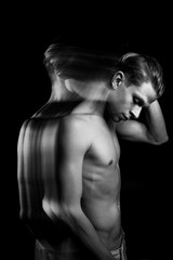 pensive man touches his head. sexy naked torso black and white portrait. long exposure creative Technic. looking side. 