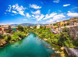 Fototapeta na wymiar Nerteva River and Old City of Mostar, with Ottoman Mosque during sunny day