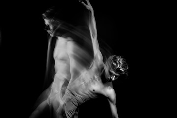 athletic Dancing creative long exposure naked torso man. Fit body.  graceful and exciting hand up. Black and white series of long exposure creative photo series. Emotional abstract inspiration