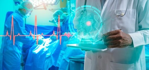 Doctor with virtual reality in operation room in hospital.Surgeon analyzing patient heart testing result and human anatomy on technological digital futuristic virtual interface,digital holographic.