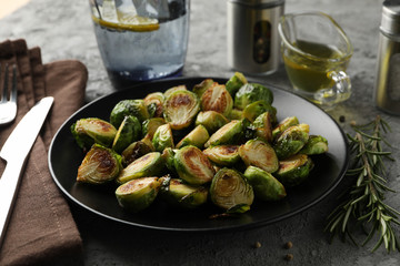 Composition with fried brussels sprout on grey background, close up