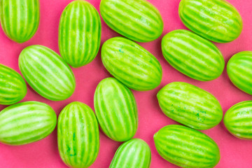 Summer colorful pink background with green melon sweets