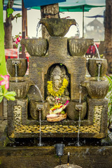 Statue and Balinese offering in Bali, Indonesia