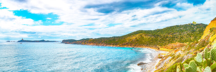 Fantastic view of Capo Carbonara beach with turquoise water and lighthouse.