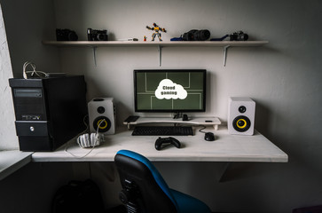 Cloud gaming: the workplace of a professional gamer with a monitor, gamepad, headphones and an armchair.
