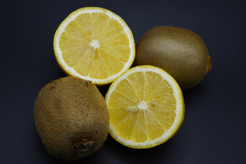 fresh lemon and kiwi on dark background