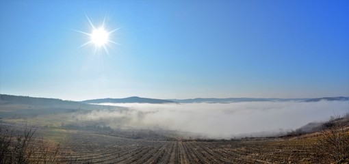 landscape with fog between hills