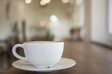 white coffee cup on table in shop.