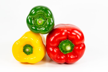 red, green and yellow capsicum fruit illustrating a healthy lifestyle isolated on white background