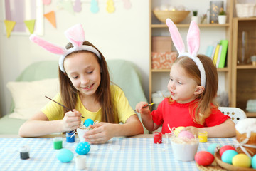 Children paint Easter eggs for the holiday.