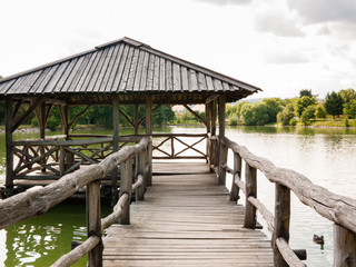 Fototapeta na wymiar Wooden shelter on a quiet lake