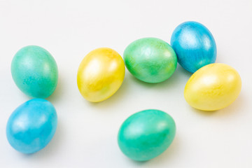 multicolored bright easter eggs on a white background, top view