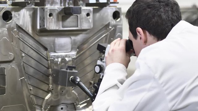 Quality Engineer Checks Deficiencies on the Injection Mold by a Microscope, Checking the Technical Condition of the Injection Mold in Automotive Factory, Industrial Concept