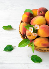 .Peaches with leaves in a basket
