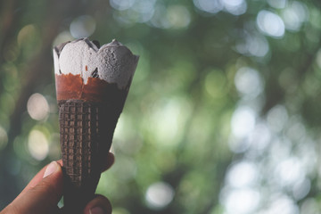 Man hand holding ice cream chocolate wafer cone