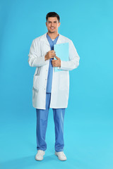 Doctor in uniform with clipboard on blue background