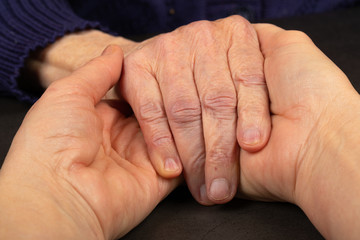 Wrinkled senior hands