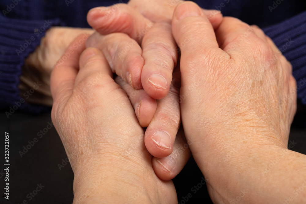 Sticker wrinkled senior hands