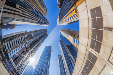 Skyscrapers against sunshine by fisheye in Dubai, United Arab Emirates