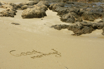 Text on white sand Good Morning