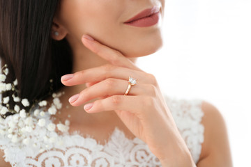 Young bride wearing beautiful engagement ring, closeup
