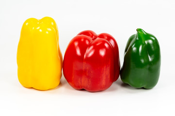 red, green and yellow capsicum fruit illustrating a healthy lifestyle isolated on white background