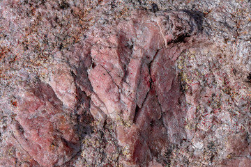 Close up of a pink quartz rock outdoors in the nature