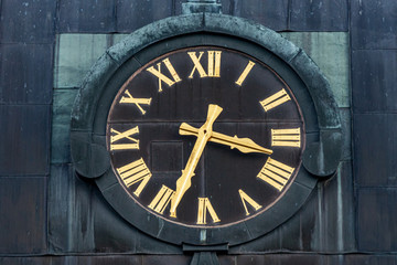 Fototapeta premium Old church clock with golden roman numbers and dials