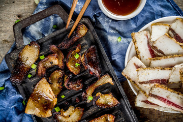 Korean traditional national food. Asian food. Korean food frozen pork belly, Sliced pork belly, Samgyeopsal. Grilled pork lard, with sauces and herbs.