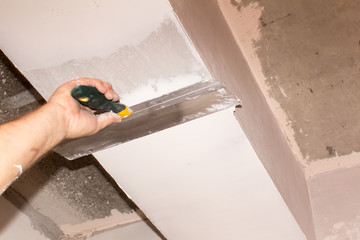 man spits walls in the house