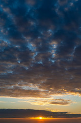 Fantastic clouds at sunrise, vertical panorama