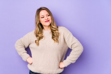 Fototapeta premium Young caucasian woman isolated on purple background dreaming of achieving goals and purposes