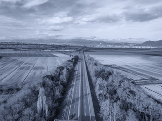 Aerial drone view of the highway between country areas, Tuscany, Italy