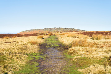 Wide footpath leads up to Stanage Edge in the Derbyshire Peak District