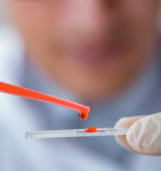 Young doctor doing the blood test