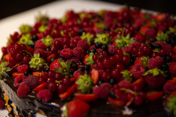 Delicious cake with lot of berries on top.