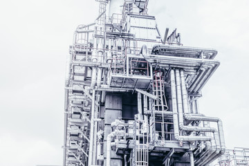 Obraz premium Industrial zone,The equipment of oil refining,Close-up of industrial pipelines of an oil-refinery plant,Detail of oil pipeline with valves in large oil refinery.