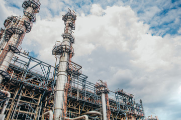 Fototapeta premium Industrial zone,The equipment of oil refining,Close-up of industrial pipelines of an oil-refinery plant,Detail of oil pipeline with valves in large oil refinery.