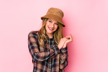 Young caucasian woman wearing a hat isolated feeling energetic and comfortable, rubbing hands confident.