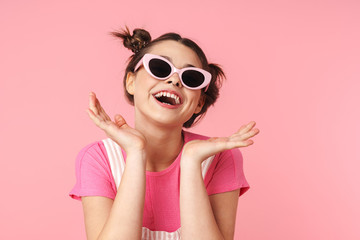 Photo of joyful charming girl in sunglasses posing and laughing