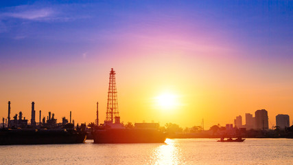 Obraz premium Oil refinery or petrochemical industry with ship in thailand. for Logistic Import Export background.