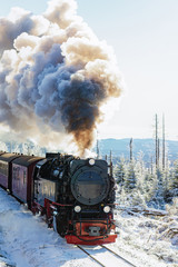 an old steam locomotive in snow-covered landscape