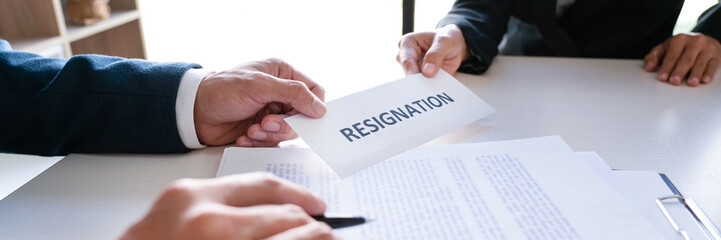 Businessman sending resignation letter to the executive employer boss on desk in order to resign dismiss contract, job placement and vacancies concept.