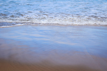 Light reflecting on breaking waves creating pastel prisms