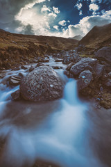 Exotic aurora landscapes with waterfalls, night sky and rugged formations.