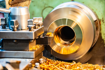 Bronze on a lathe, processing and manufacturing of parts from brass on a CNC machine.