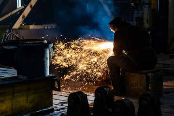 Welding with a graphite electrode, a lot of sparks fly in different directions. Fireworks from the...