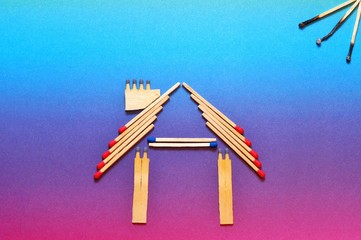 Fire insurance, house made of matches. abstract house made with matches on paper background, copy space. Concept of home protection insurance with the importance of smoke alarm and security systems