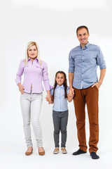 Obraz premium Happy young family with pretty child posing on white background